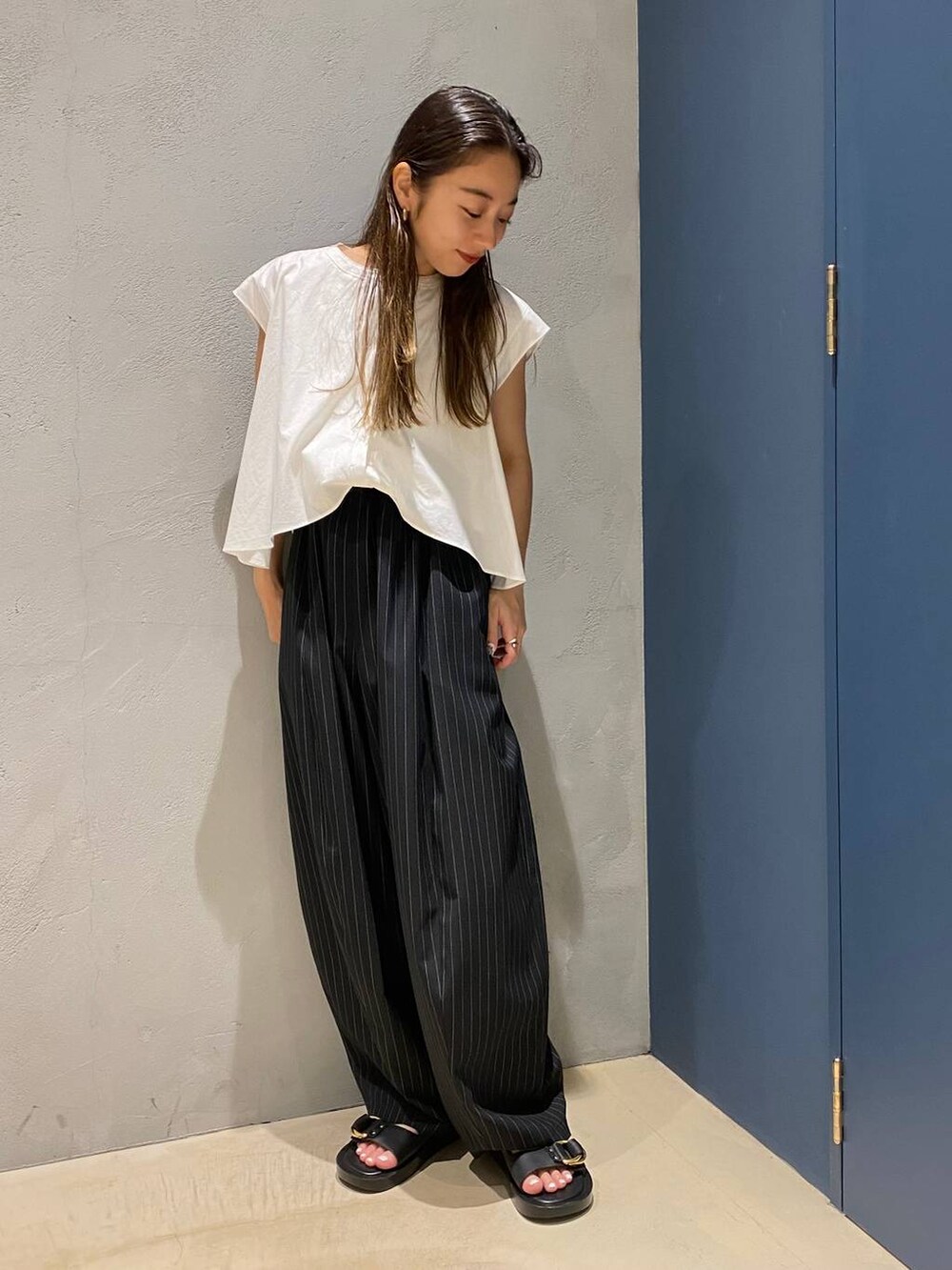 ブラック系のサンダル、ホワイト系のシャツ/ブラウス、ブラック系のその他パンツを着用したレディースの夏コーディネートの3枚目の写真