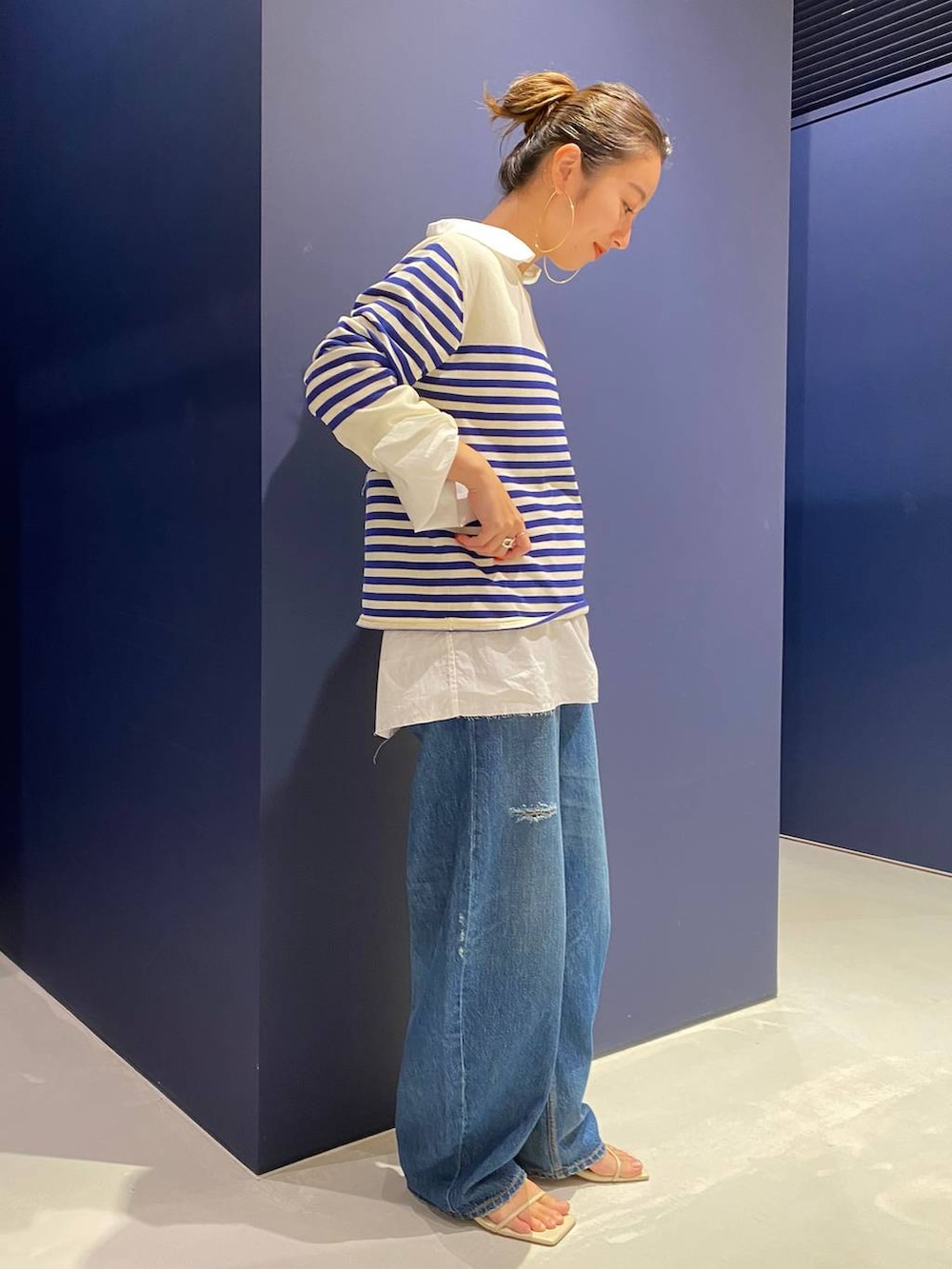 ブルー系のデニムパンツ、ホワイト系のシャツ/ブラウス、ホワイト系のニット/セーターを着用したレディースの夏コーディネートの4枚目の写真