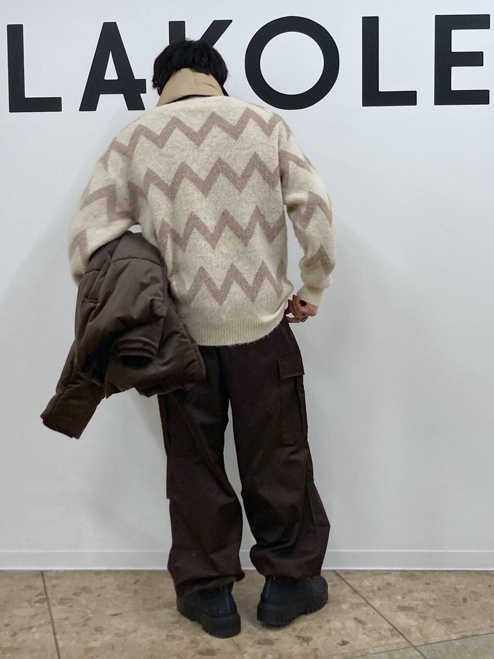 ベージュ系のニット/セーター、ブラウン系のカーゴパンツ、ブラウン系のブルゾンを着用したメンズの冬コーディネートの6枚目の写真