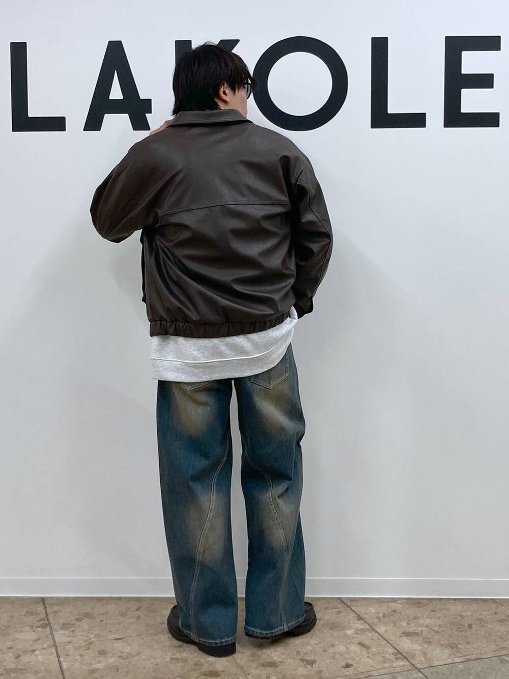ブルー系のデニムパンツ、グレー系のスウェット、ブラック系のローファーを着用したメンズの冬コーディネートの2枚目の写真