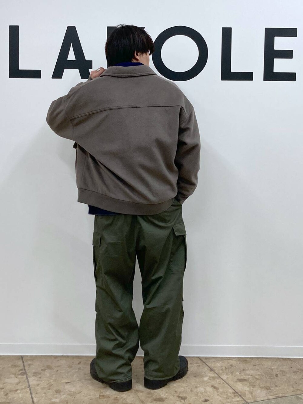 グリーン系のカーゴパンツ、ブラウン系のブルゾン、ブルー系のデニムジャケットを着用したメンズの冬コーディネートの2枚目の写真