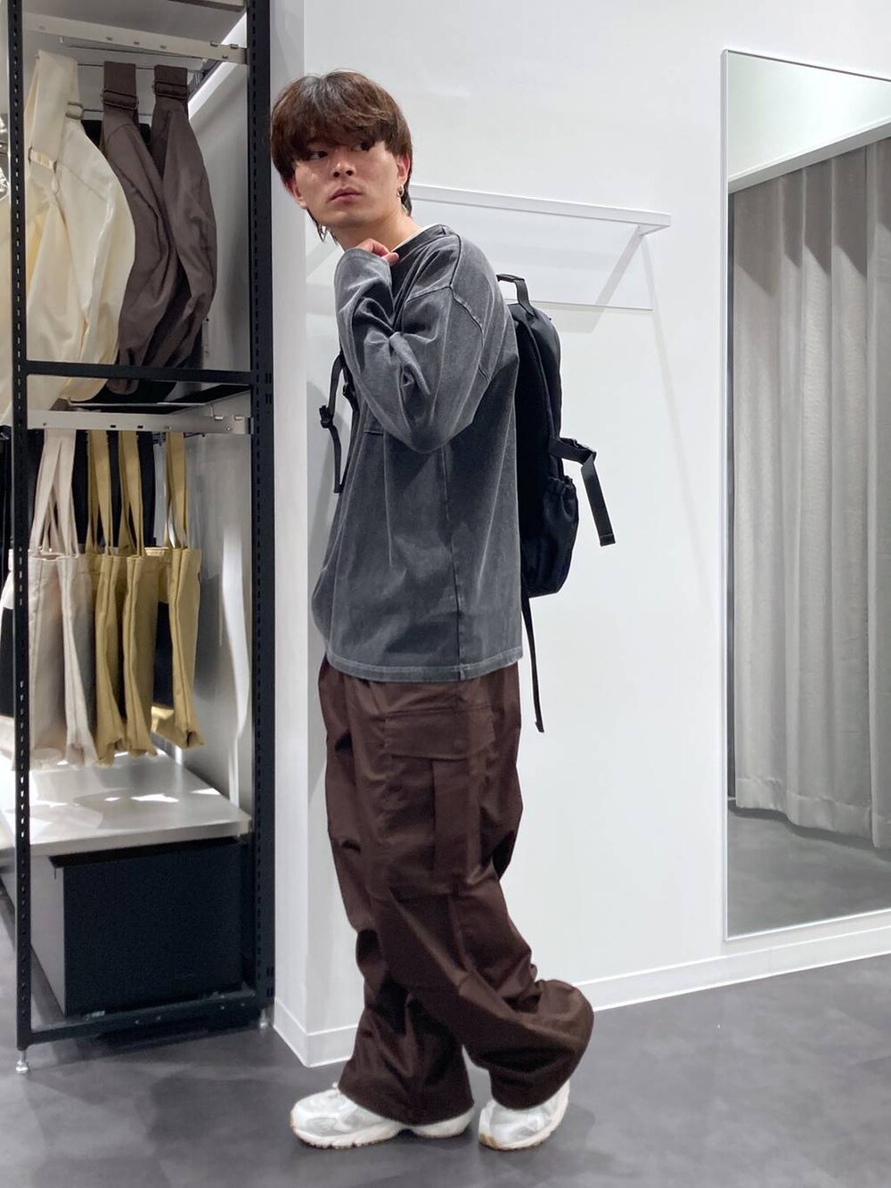 ホワイト系のTシャツ/カットソー、ブラウン系のカーゴパンツ、ブラック系のバックパック/リュックを着用したメンズの夏コーディネートの3枚目の写真
