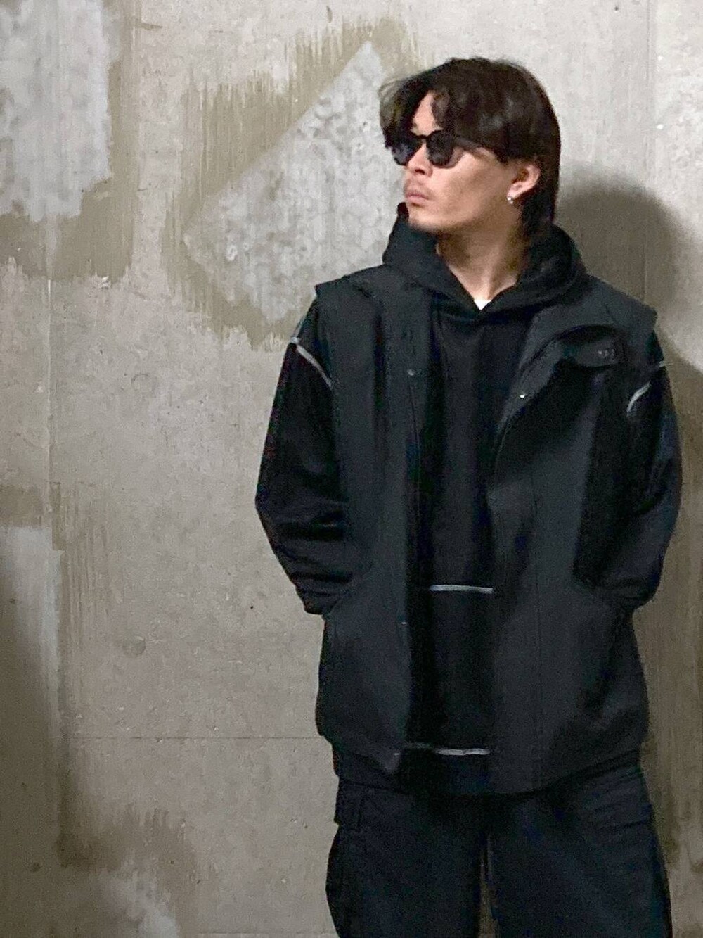 ブラック系のTシャツ/カットソー、ブラック系のカーゴパンツ、ブラック系のブルゾンを着用したメンズの秋コーディネートの7枚目の写真