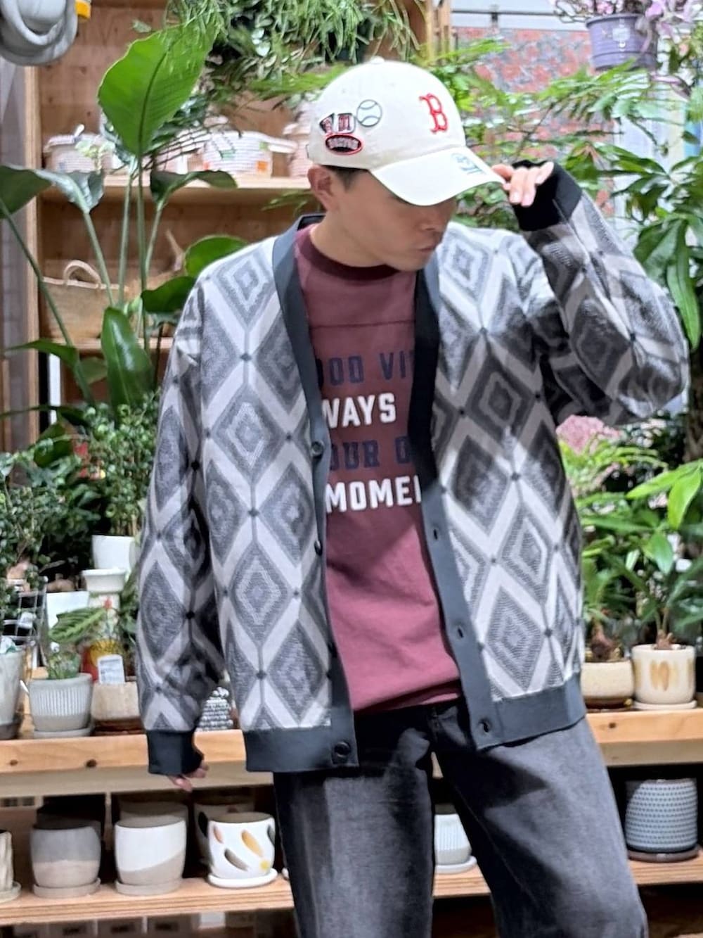 ブラック系のデニムパンツ、レッド系のTシャツ/カットソー、グレー系のカーディガン/ボレロを着用したメンズの秋コーディネートの8枚目の写真