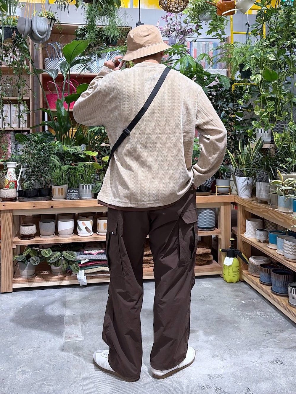 ベージュ系のTシャツ/カットソー、ブラウン系のカーゴパンツ、ベージュ系のハットを着用したメンズの秋コーディネートの2枚目の写真