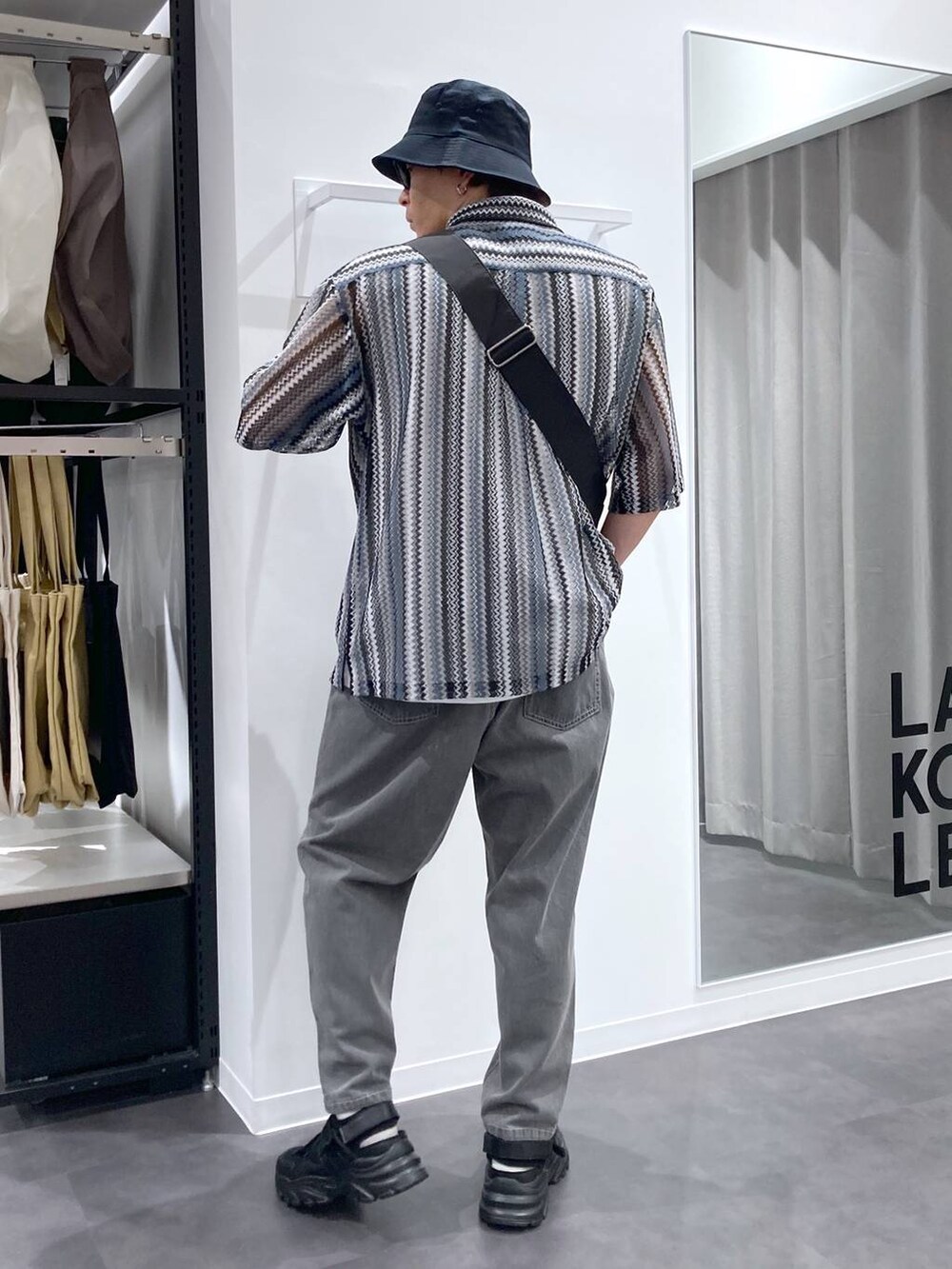 ブラック系のスニーカー、ブラック系のシャツ/ブラウス、ホワイト系のTシャツ/カットソーを着用したメンズの夏コーディネートの2枚目の写真