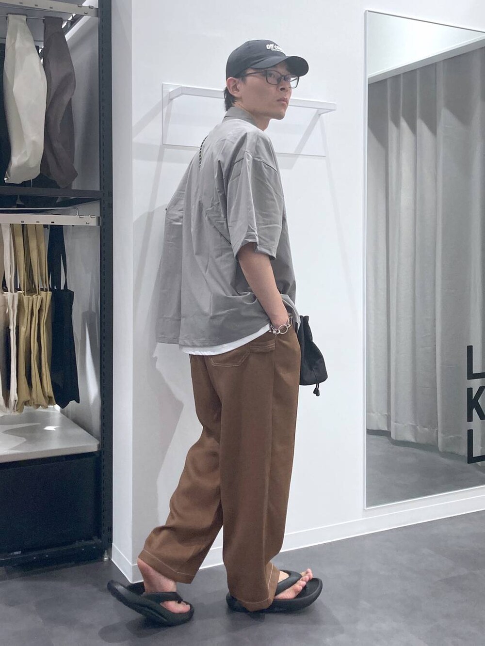 ブラック系のサンダル、ブラウン系のその他パンツ、ホワイト系のTシャツ/カットソーを着用したメンズの夏コーディネートの3枚目の写真