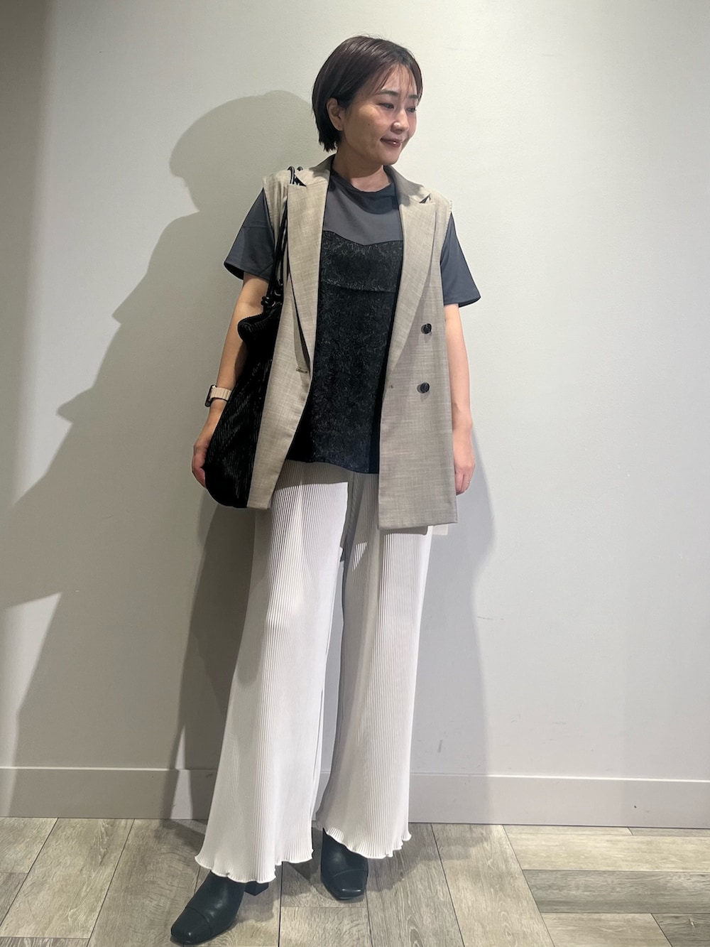 ホワイト系のその他パンツ、ブラウン系のベスト、ブラック系のTシャツ/カットソーを着用したレディースの夏コーディネートの5枚目の写真