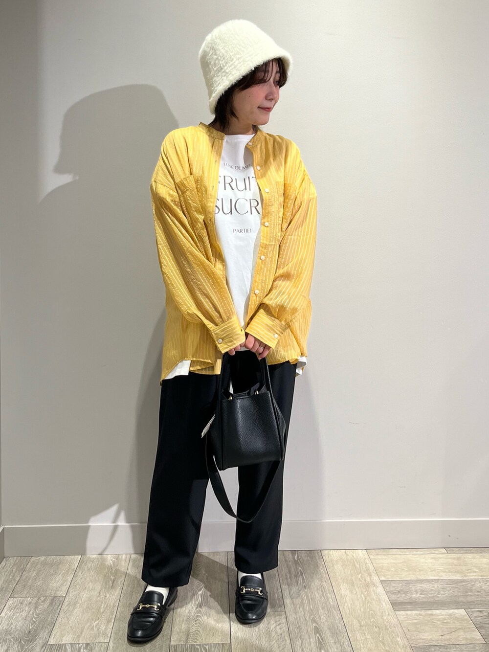 イエロー系のシャツ/ブラウス、ブラック系のその他パンツを着用したレディースの秋コーディネートの5枚目の写真