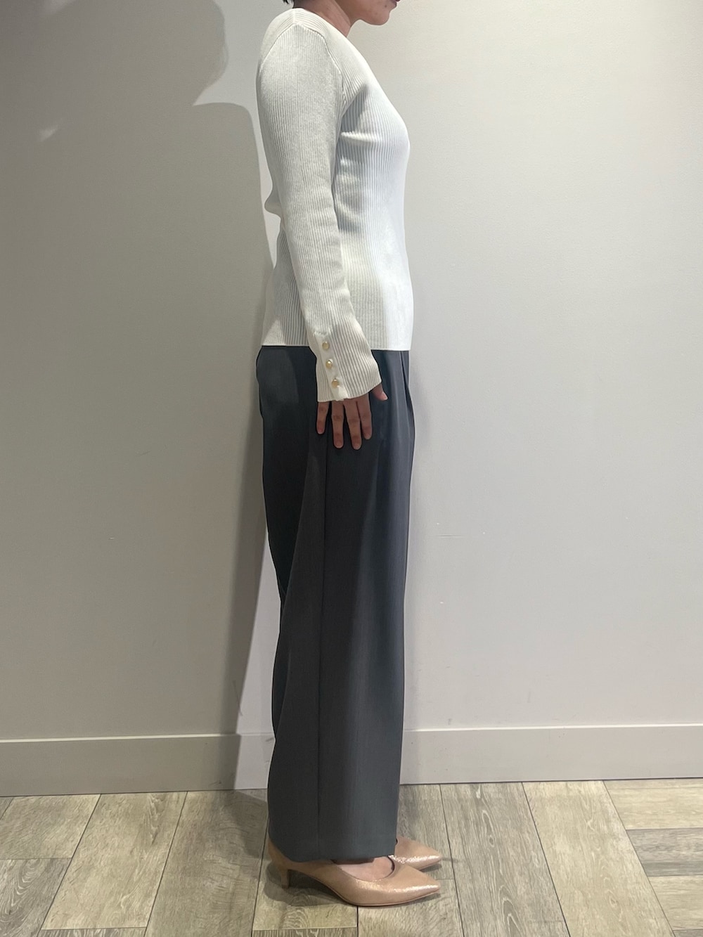 グレー系のテーラードジャケット、グレー系のスラックス、ホワイト系のニット/セーターを着用したレディースの冬コーディネートの3枚目の写真