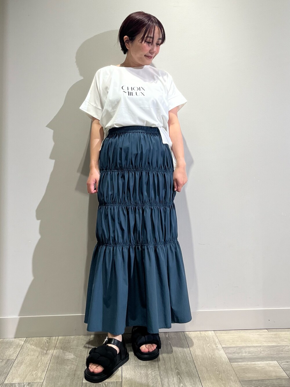 ブラック系のテーラードジャケット、ホワイト系のTシャツ/カットソー、ブラウン系のかごバッグを着用したレディースの春コーディネートの2枚目の写真