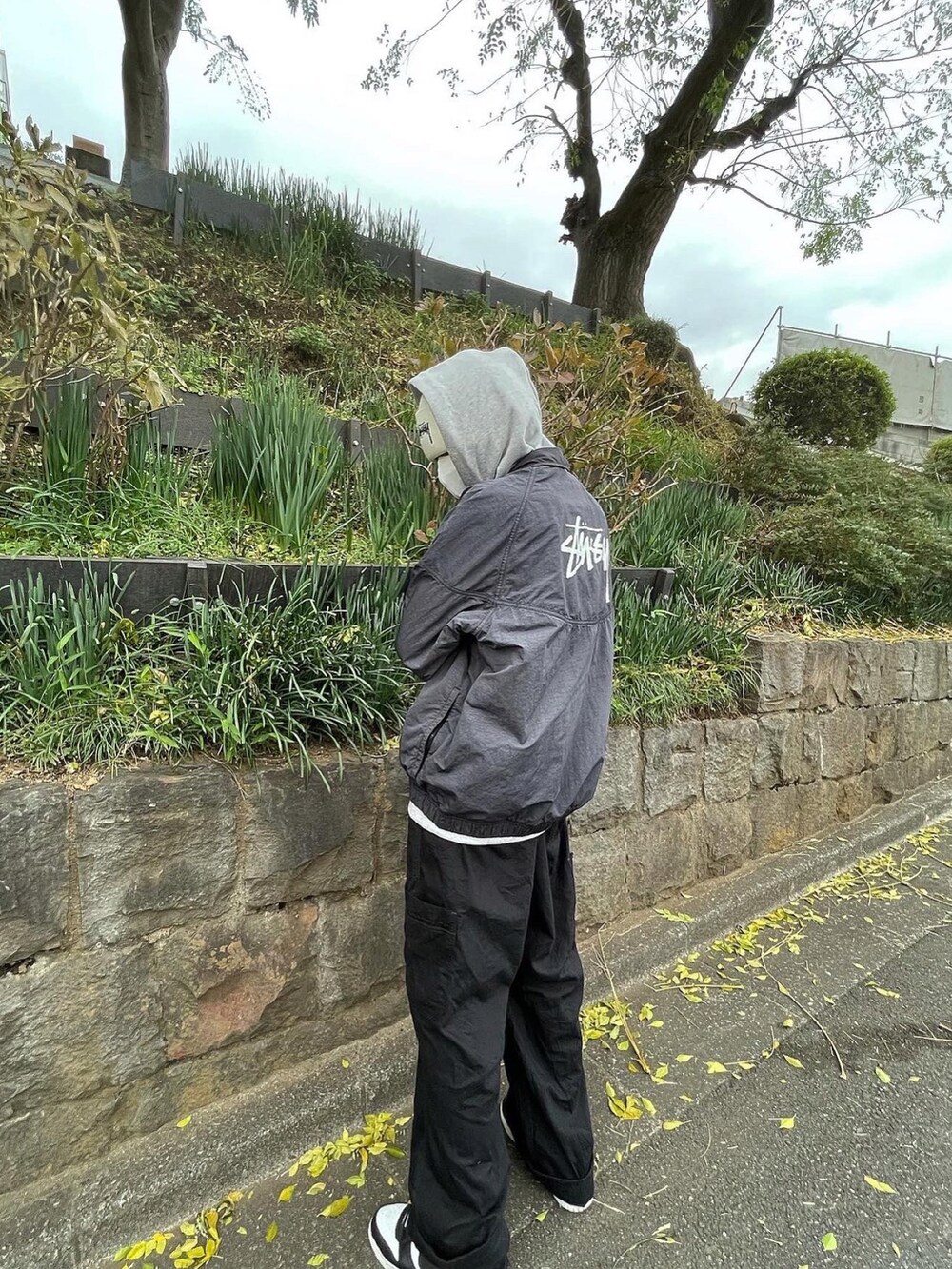 ブラック系のカーゴパンツ、ブラック系のスニーカー、ブルー系のジャケット/アウターを着用したメンズの冬コーディネートの2枚目の写真