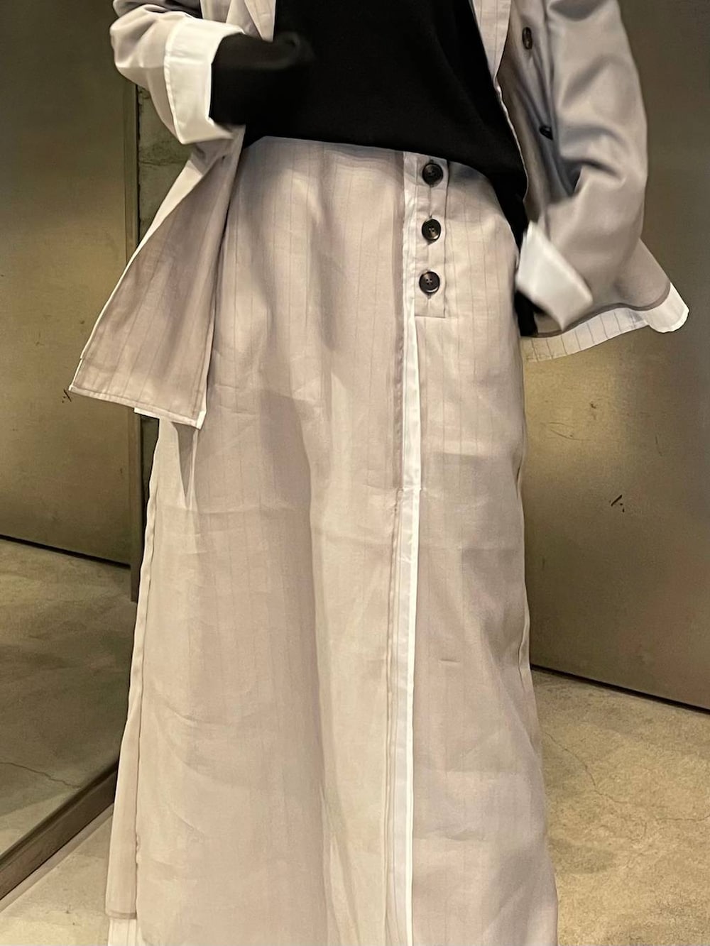 ブラック系のサンダル、ベージュ系のスカート、ベージュ系のテーラードジャケットを着用したレディースの春コーディネートの5枚目の写真