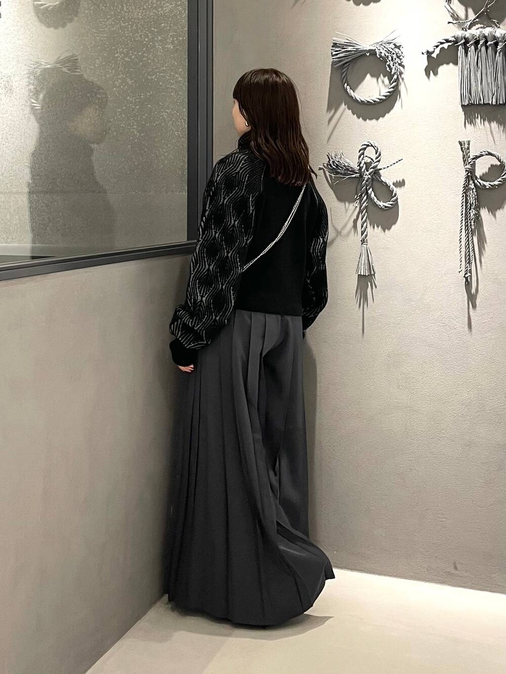 ブラック系のブーツ、グレー系のその他パンツ、ブラック系のカーディガン/ボレロを着用したレディースの秋コーディネートの2枚目の写真