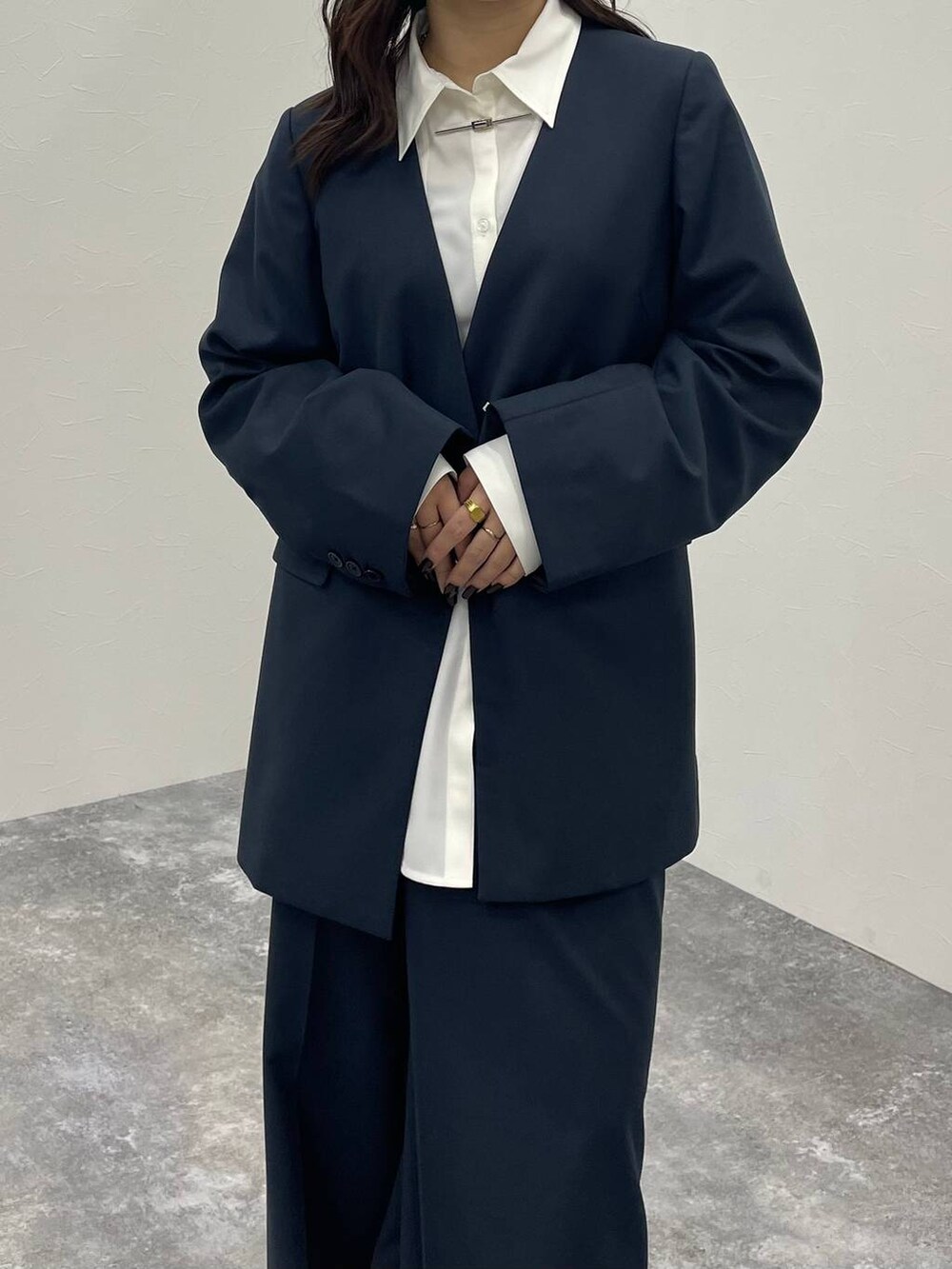 ブラック系のブーツ、ホワイト系のシャツ/ブラウス、グレー系のノーカラージャケットを着用したレディースの秋コーディネートの4枚目の写真