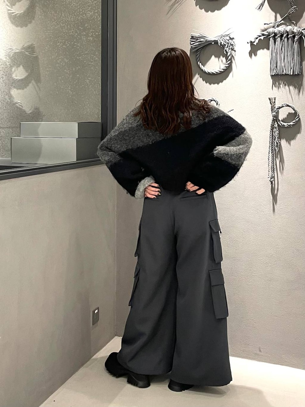 グレー系のカーゴパンツ、ブラック系のブーツ、ブルー系のシャツ/ブラウスを着用したレディースの冬コーディネートの3枚目の写真