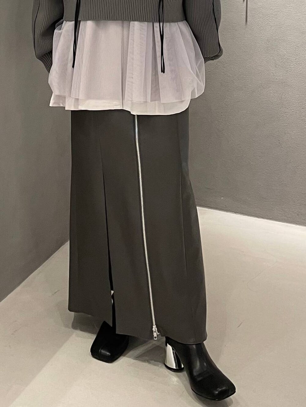 ブラック系のブーツ、グレー系のシャツ/ブラウス、グレー系のニット/セーターを着用したレディースの冬コーディネートの5枚目の写真