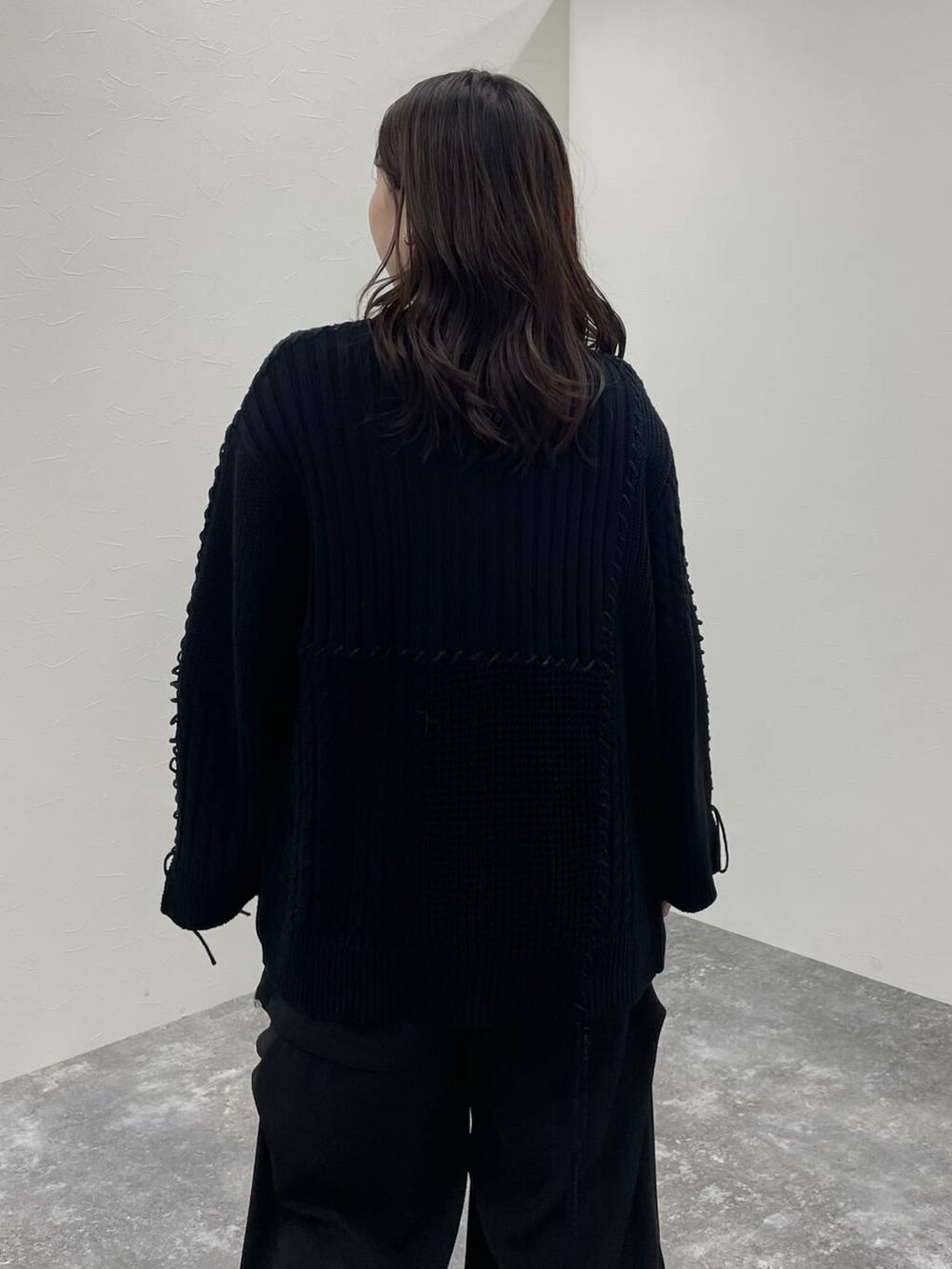 ブラック系のカーディガン/ボレロ、ブラック系のカーゴパンツ、ブラック系のブーツを着用したレディースの秋コーディネートの5枚目の写真