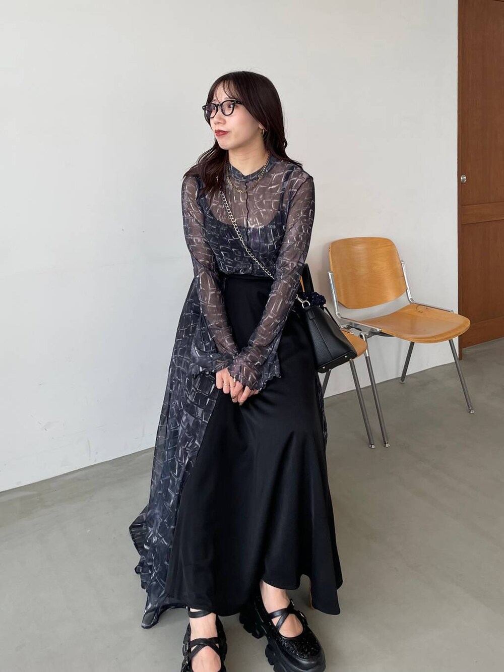 ブラック系のスニーカー、ブラック系のTシャツ/カットソー、ブルー系のショルダーバッグを着用したレディースの夏コーディネートの4枚目の写真