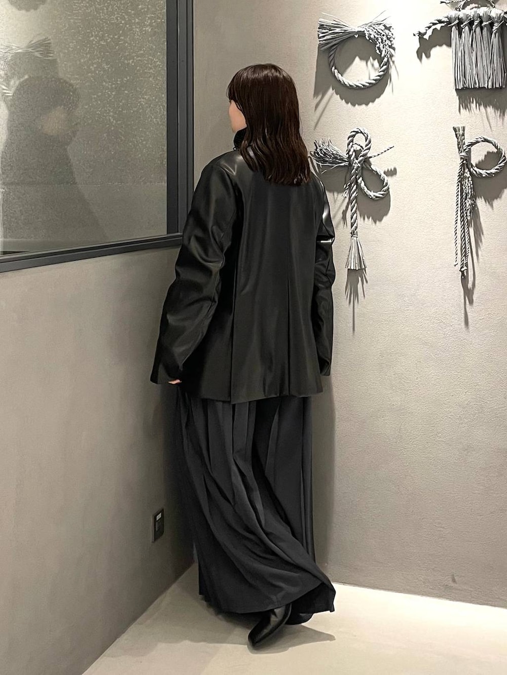 ブラック系のブーツ、グレー系のその他パンツ、ブラック系のカーディガン/ボレロを着用したレディースの秋コーディネートの3枚目の写真