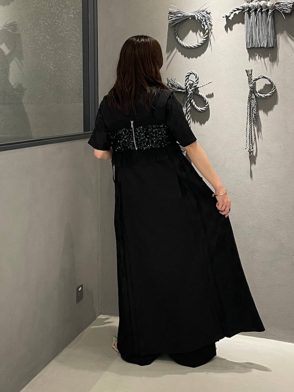 ブラック系のその他パンツ、ホワイト系のサンダル、ブラック系のチューブトップを着用したレディースの夏コーディネートの2枚目の写真