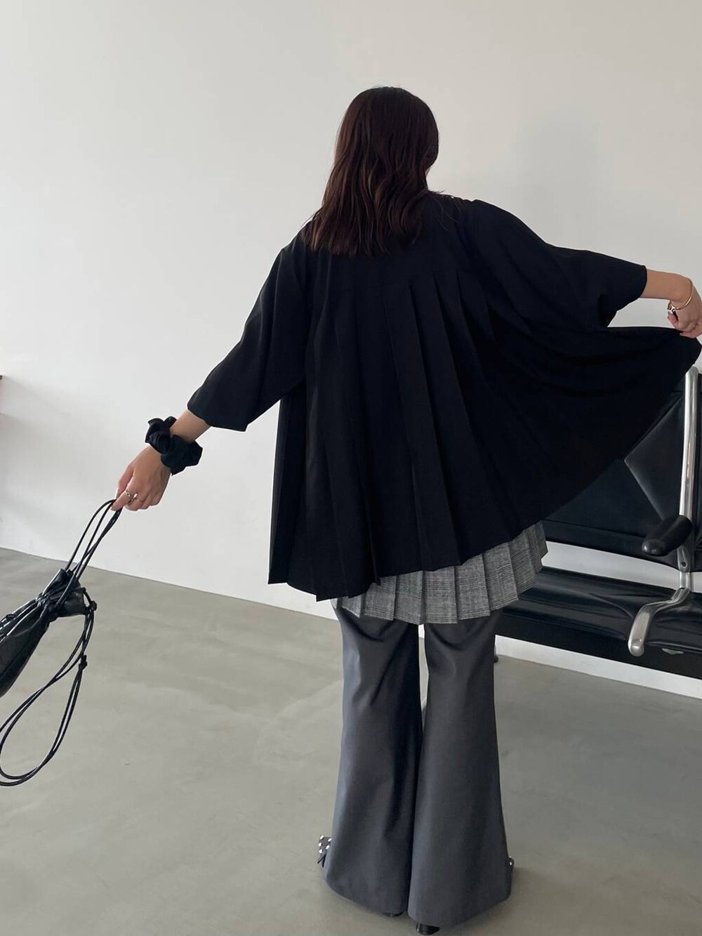 ブラック系のパンプス、ブラック系のショルダーバッグ、ブラック系のシャツ/ブラウスを着用したレディースの夏コーディネートの4枚目の写真