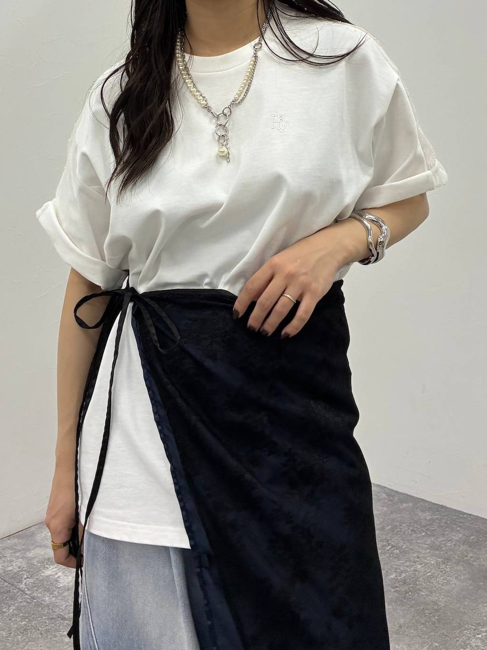 シルバー系のサンダル、ホワイト系のTシャツ/カットソー、ブルー系のデニムパンツを着用したレディースの春コーディネートの4枚目の写真