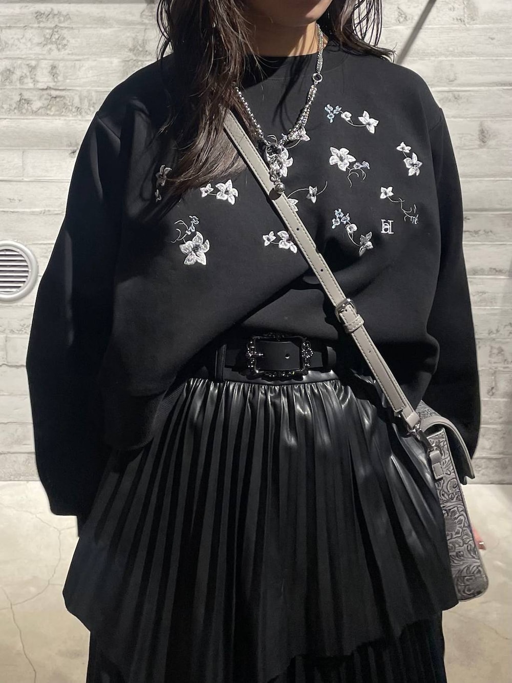 ブラック系のスウェット、グレー系のショルダーバッグ、ブラック系のスカートを着用したレディースの冬コーディネートの6枚目の写真