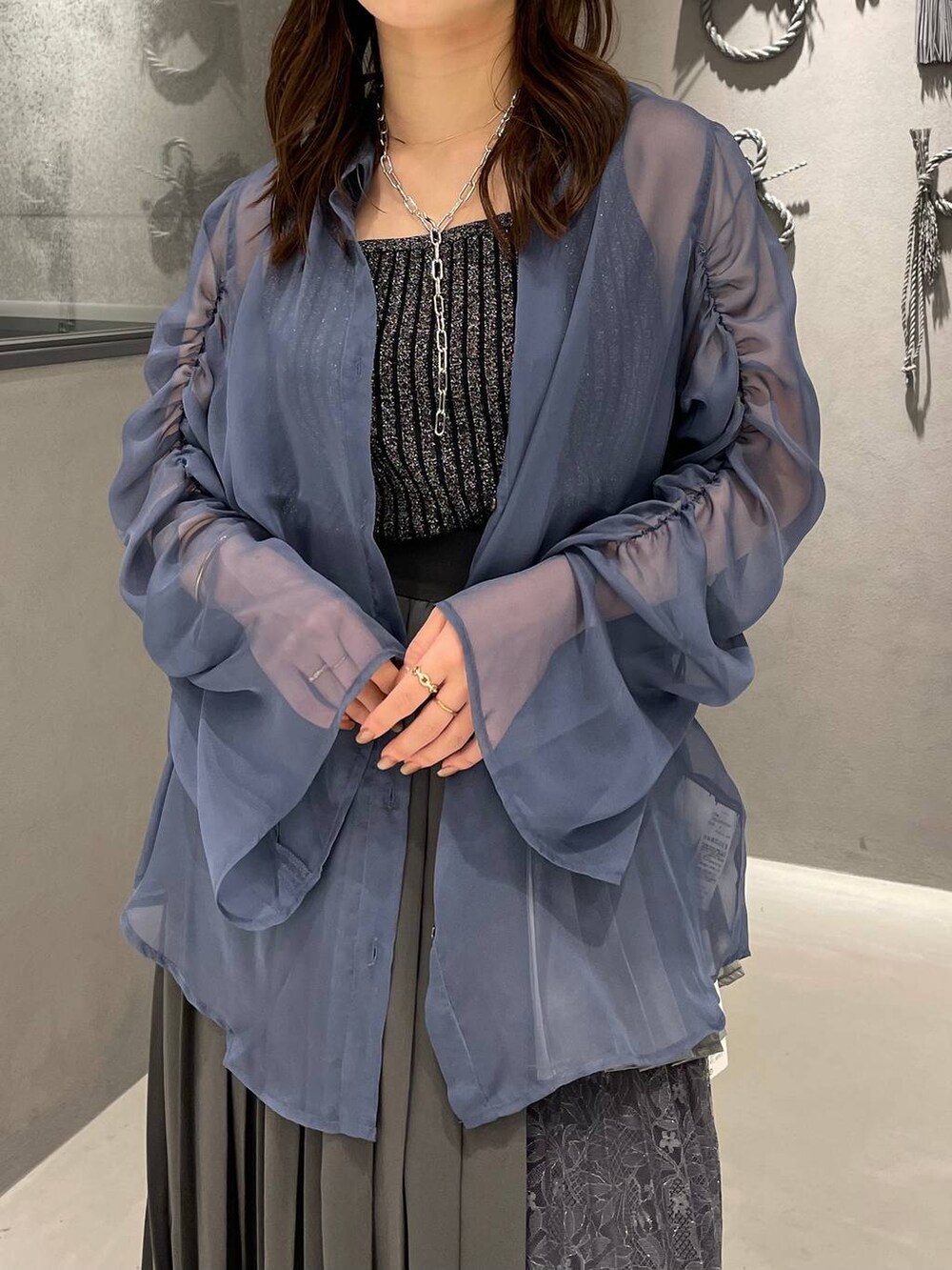 ブラック系のサンダル、ブラック系のタンクトップ、グレー系のスカートを着用したレディースの春コーディネートの4枚目の写真