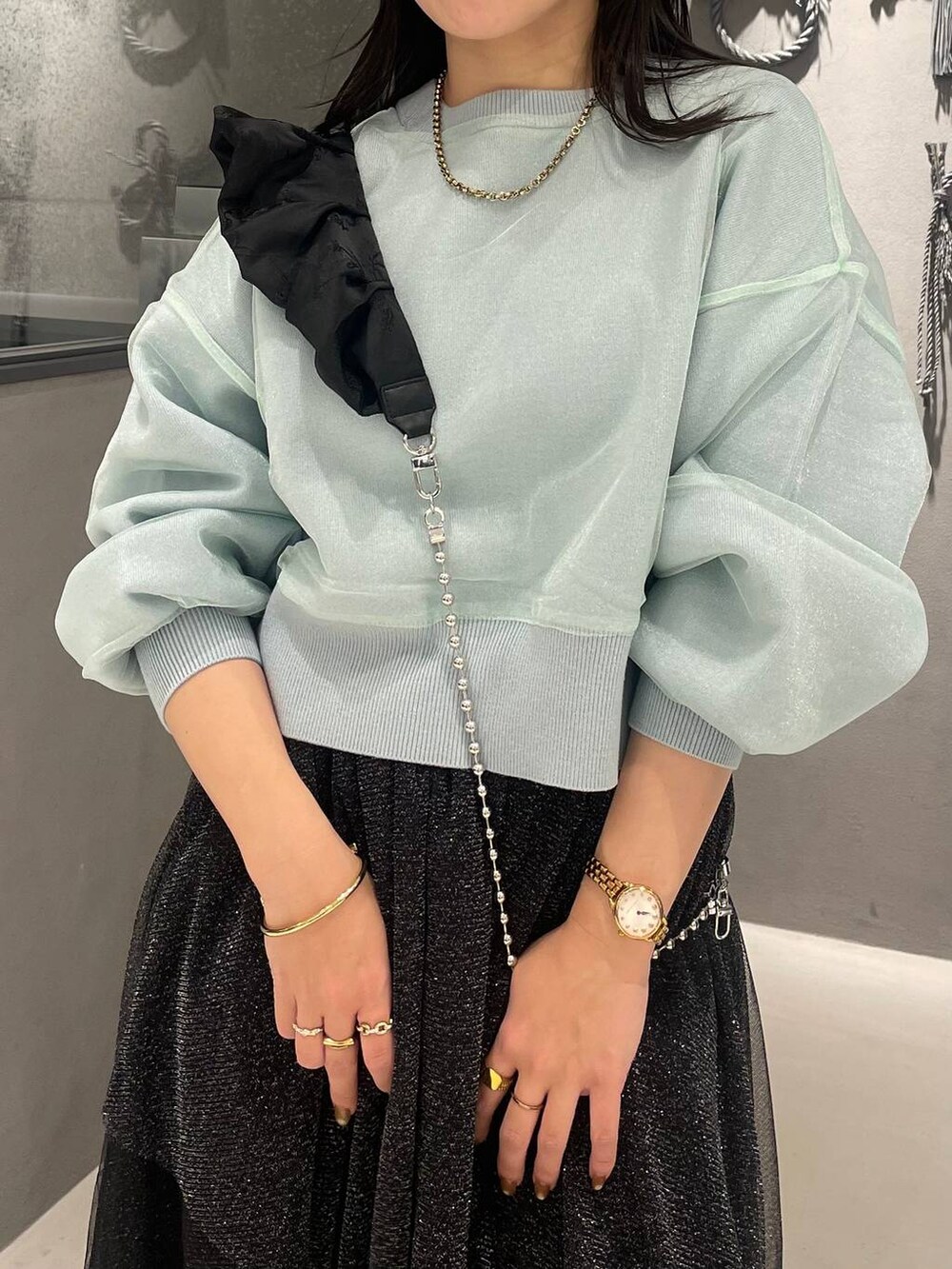 ブラック系のブーツ、グリーン系のカーディガン/ボレロ、ブラック系のスカートを着用したレディースの冬コーディネートの4枚目の写真