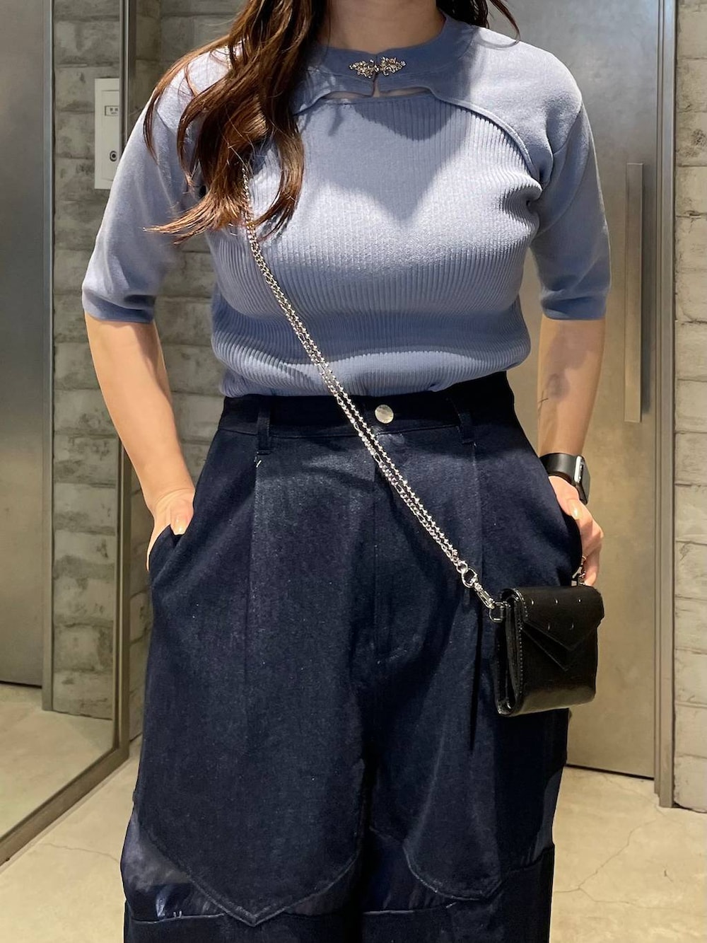 シルバー系のブーツ、ブルー系のデニムパンツ、ブルー系のニット/セーターを着用したレディースの春コーディネートの4枚目の写真