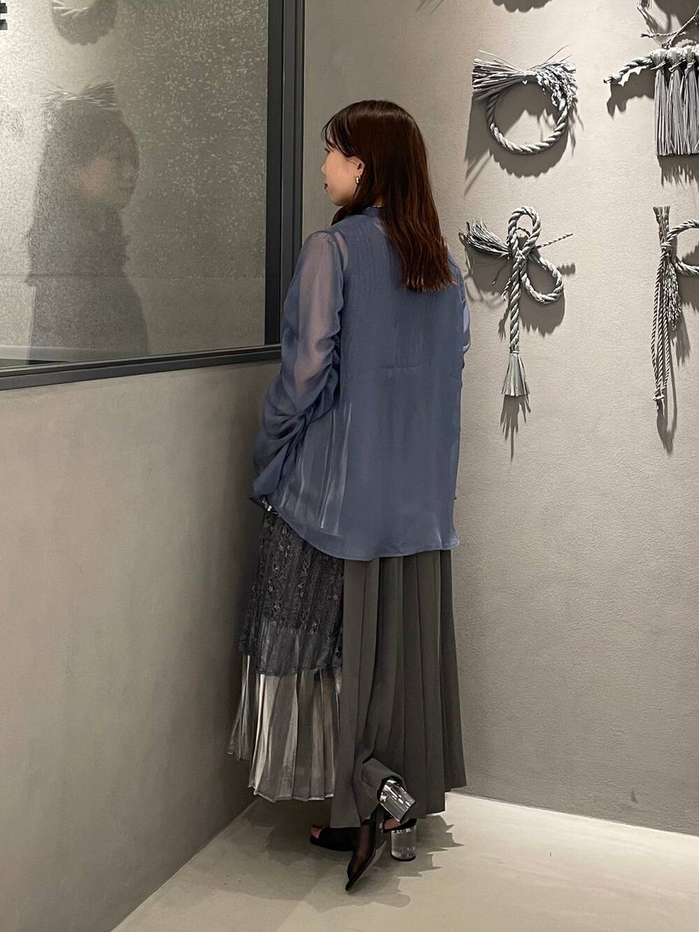 ブラック系のサンダル、ブラック系のタンクトップ、グレー系のスカートを着用したレディースの春コーディネートの2枚目の写真