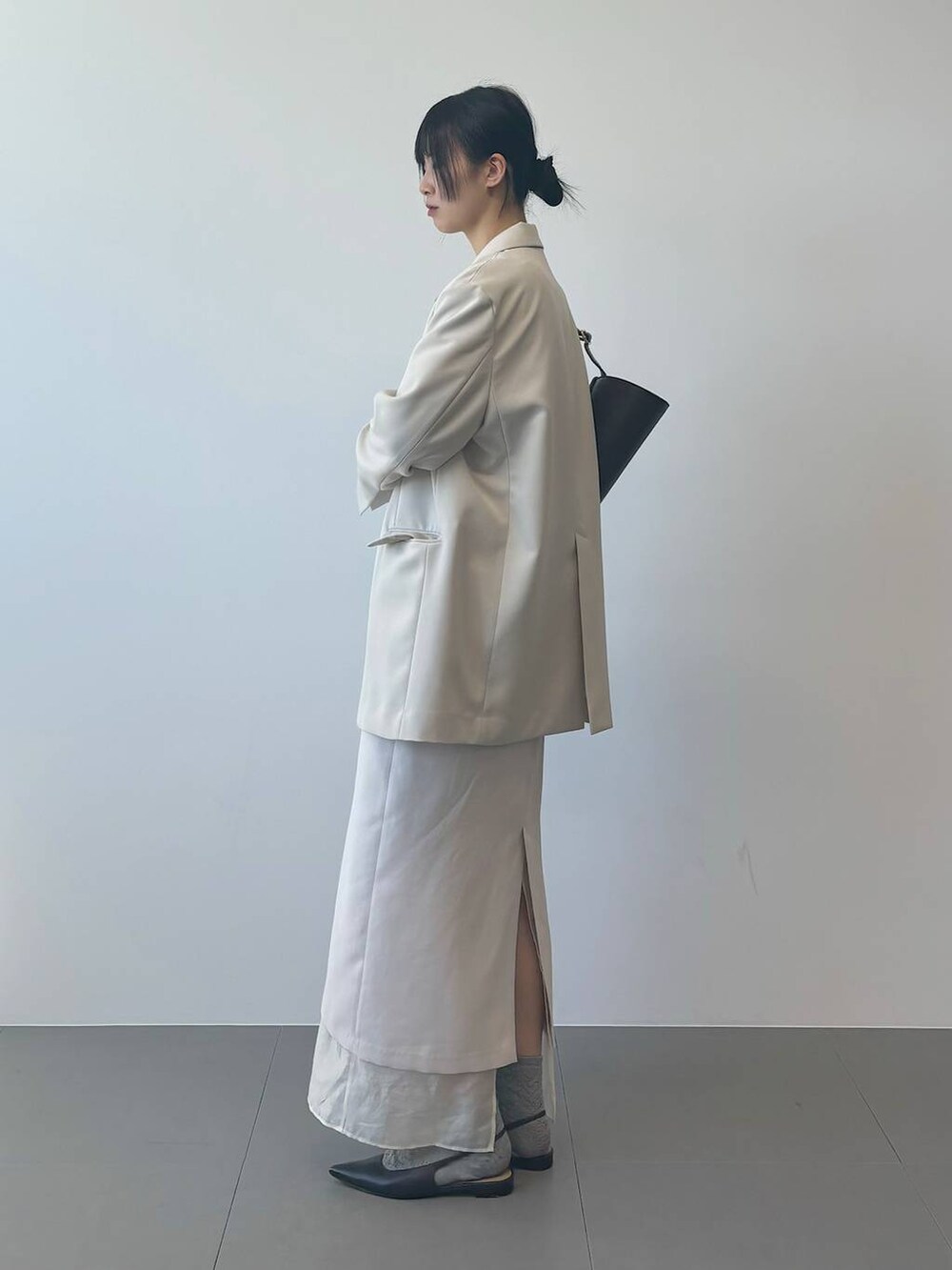 ホワイト系のTシャツ/カットソー、ベージュ系のテーラードジャケットを着用したレディースの冬コーディネートの2枚目の写真