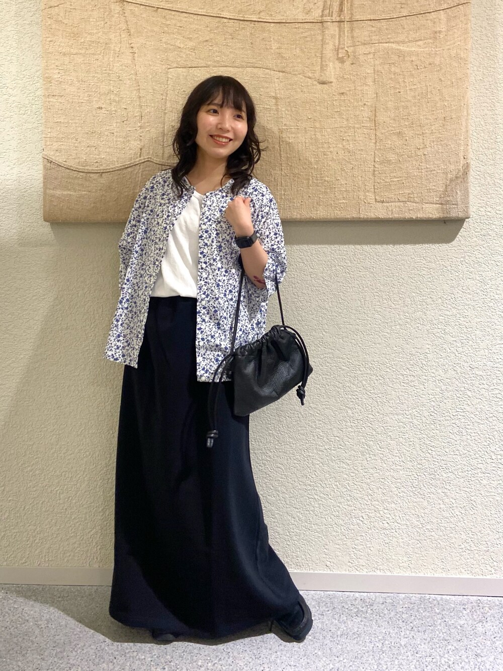 ホワイト系のカーディガン/ボレロ、ホワイト系のタンクトップ、ブラック系のスカートを着用したレディースの夏コーディネートの2枚目の写真