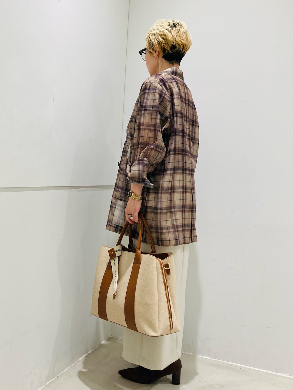 ベージュ系のテーラードジャケット、ブラウン系のTシャツ/カットソー、ベージュ系のスカートを着用したレディースの春コーディネートの2枚目の写真