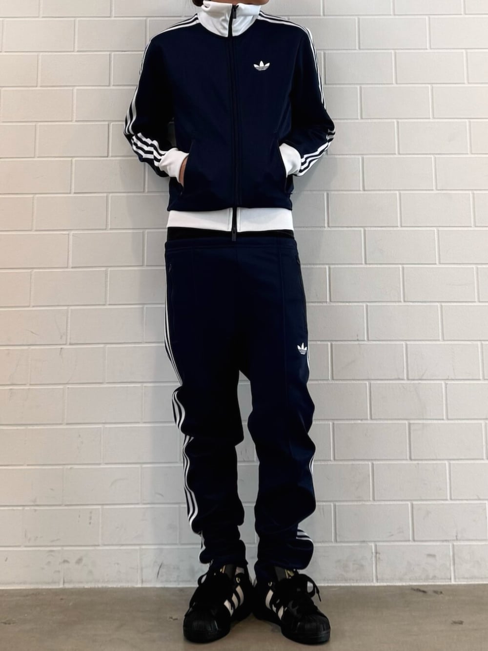 ブルー系のジャージ、ブルー系のスウェットパンツ、ブラック系のスニーカーを着用したメンズの春コーディネートの2枚目の写真