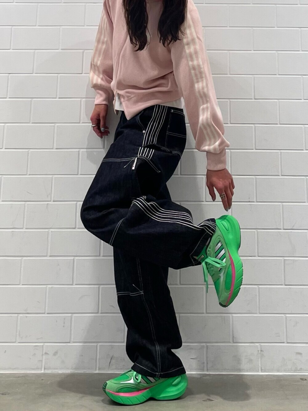 ブルー系のデニムパンツ、ピンク系のトップス、グリーン系のシューズを着用したメンズの冬コーディネートの2枚目の写真