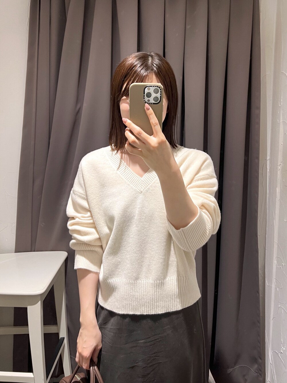 ブラウン系のその他アウター、ブラウン系のスカート、ホワイト系のニット/セーターを着用したレディースの秋コーディネートの9枚目の写真