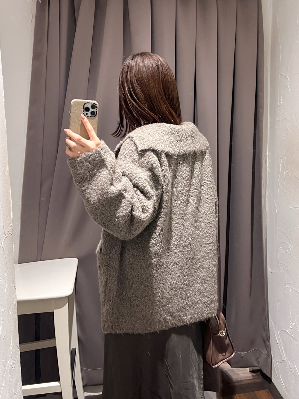 ブラウン系のその他アウター、ブラウン系のスカート、ホワイト系のニット/セーターを着用したレディースの秋コーディネートの7枚目の写真