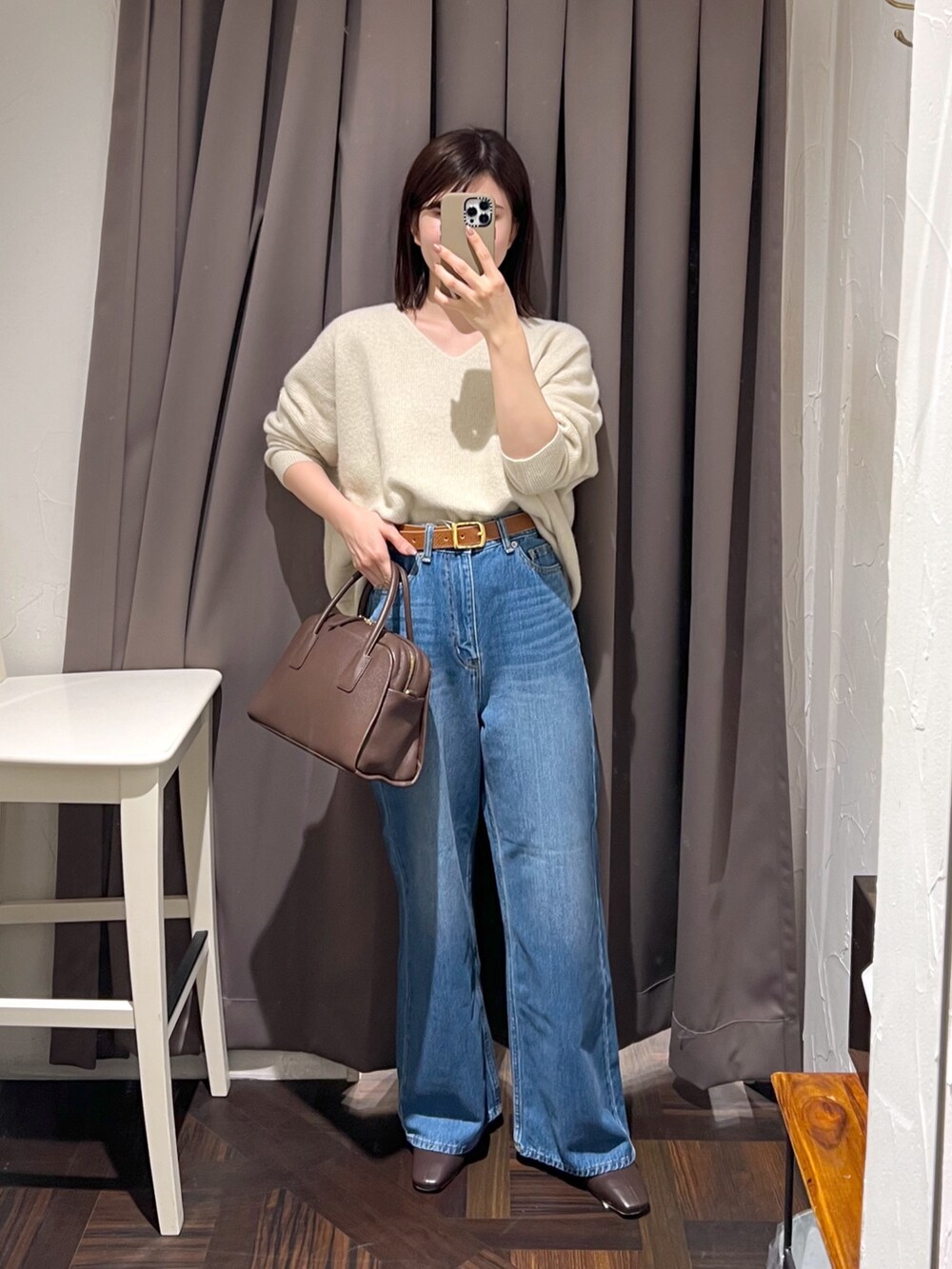 ブラウン系のステンカラーコート、ベージュ系のニット/セーター、ブラウン系のボストンバッグを着用したレディースの秋コーディネートの8枚目の写真