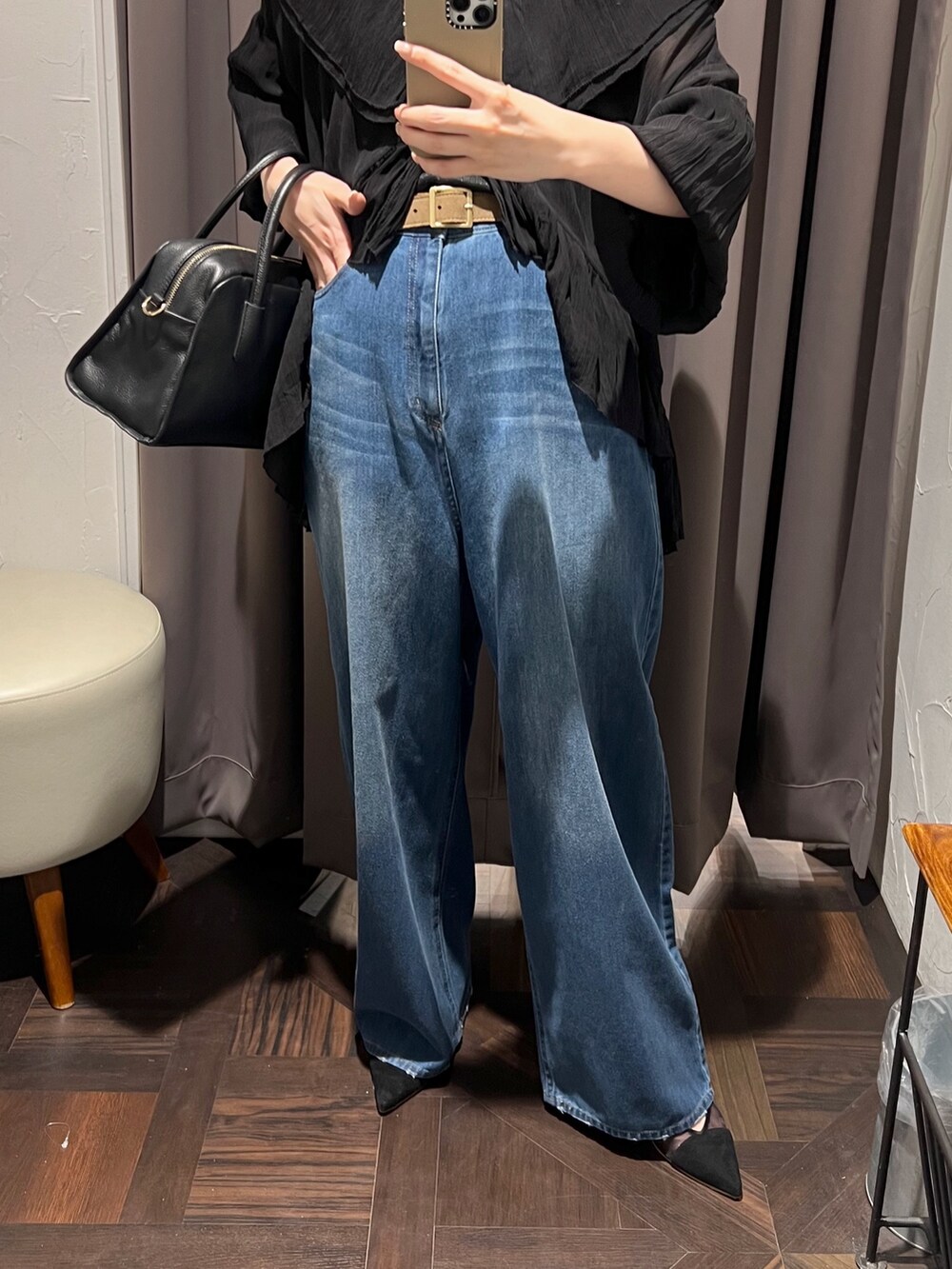 ブラック系のシャツ/ブラウス、ブルー系のデニムパンツ、ブラック系のパンプスを着用したレディースの冬コーディネートの8枚目の写真