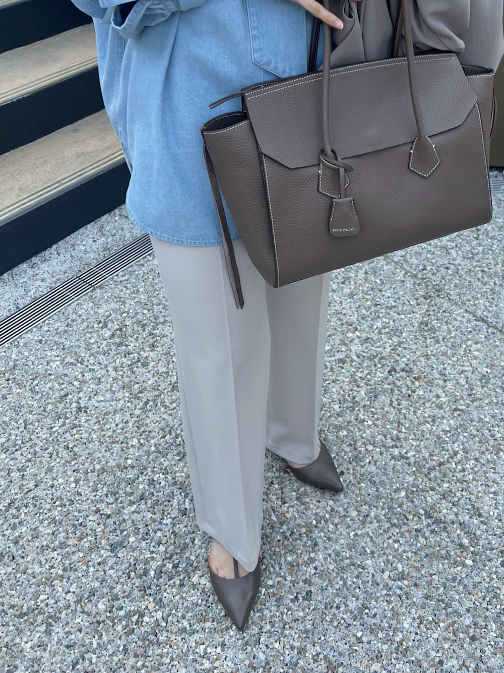 ブルー系のシャツ/ブラウス、ブラウン系のトートバッグ、ベージュ系のその他パンツを着用したレディースの冬コーディネートの5枚目の写真