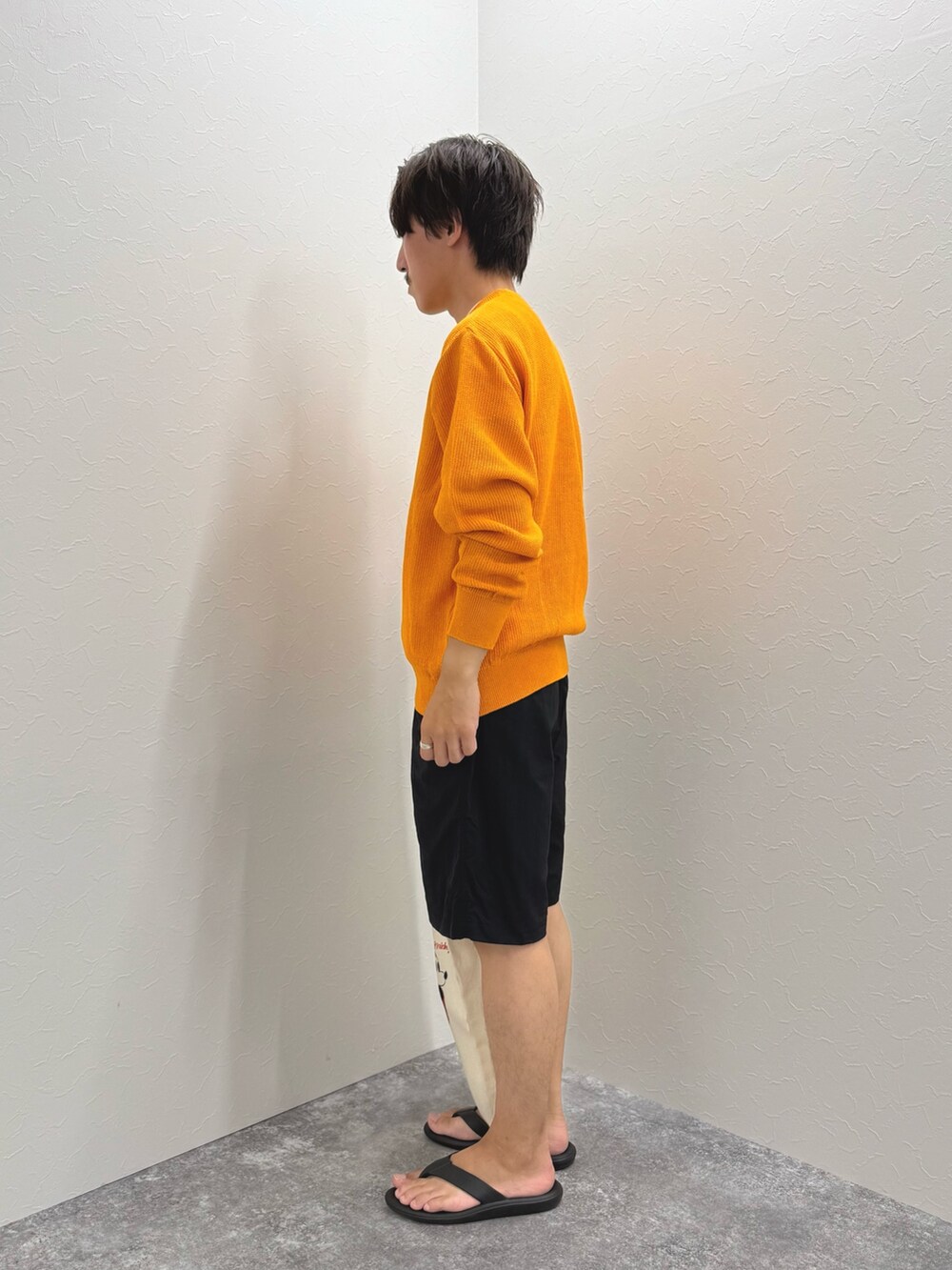ブラック系のその他パンツ、オレンジ系のニット/セーター、ブラック系のサンダルを着用したメンズの夏コーディネートの5枚目の写真