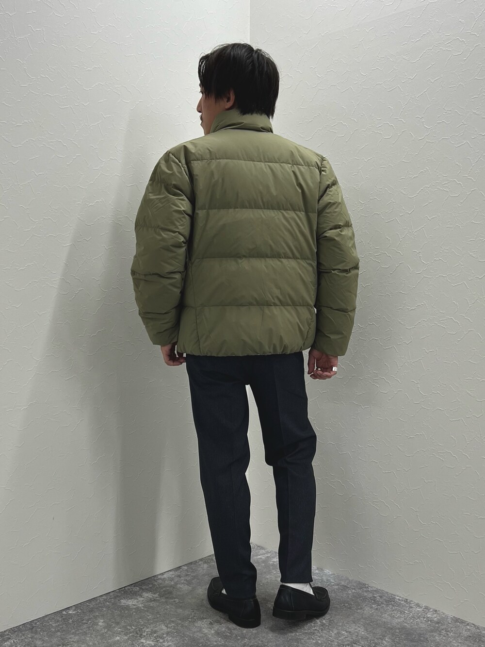 グリーン系のダウンジャケット/コート、ブルー系のTシャツ/カットソー、グレー系のその他パンツを着用したメンズの秋コーディネートの5枚目の写真