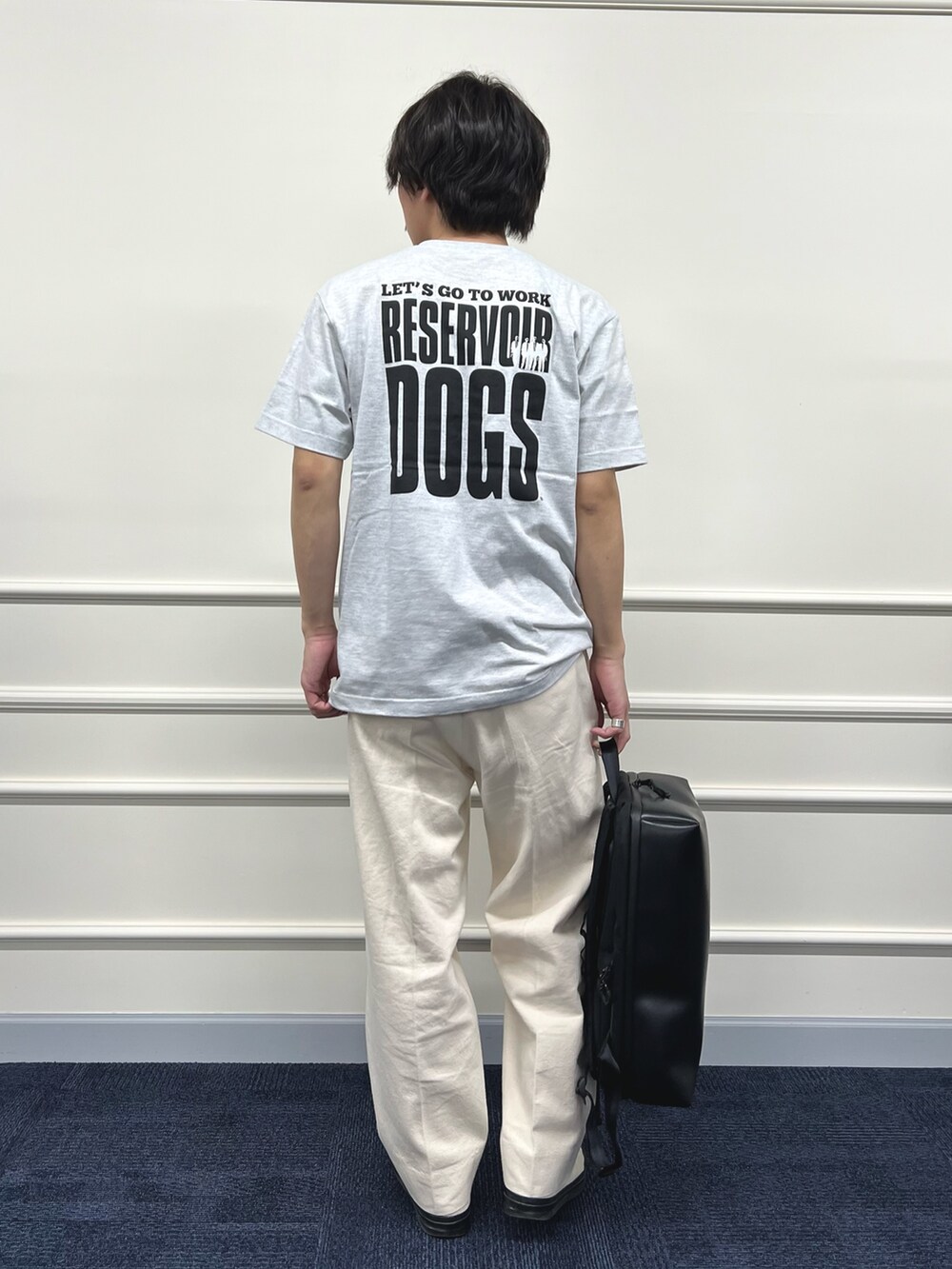 グレー系のTシャツ/カットソー、ブラック系のバックパック/リュック、ホワイト系のデニムパンツを着用したメンズの冬コーディネートの6枚目の写真