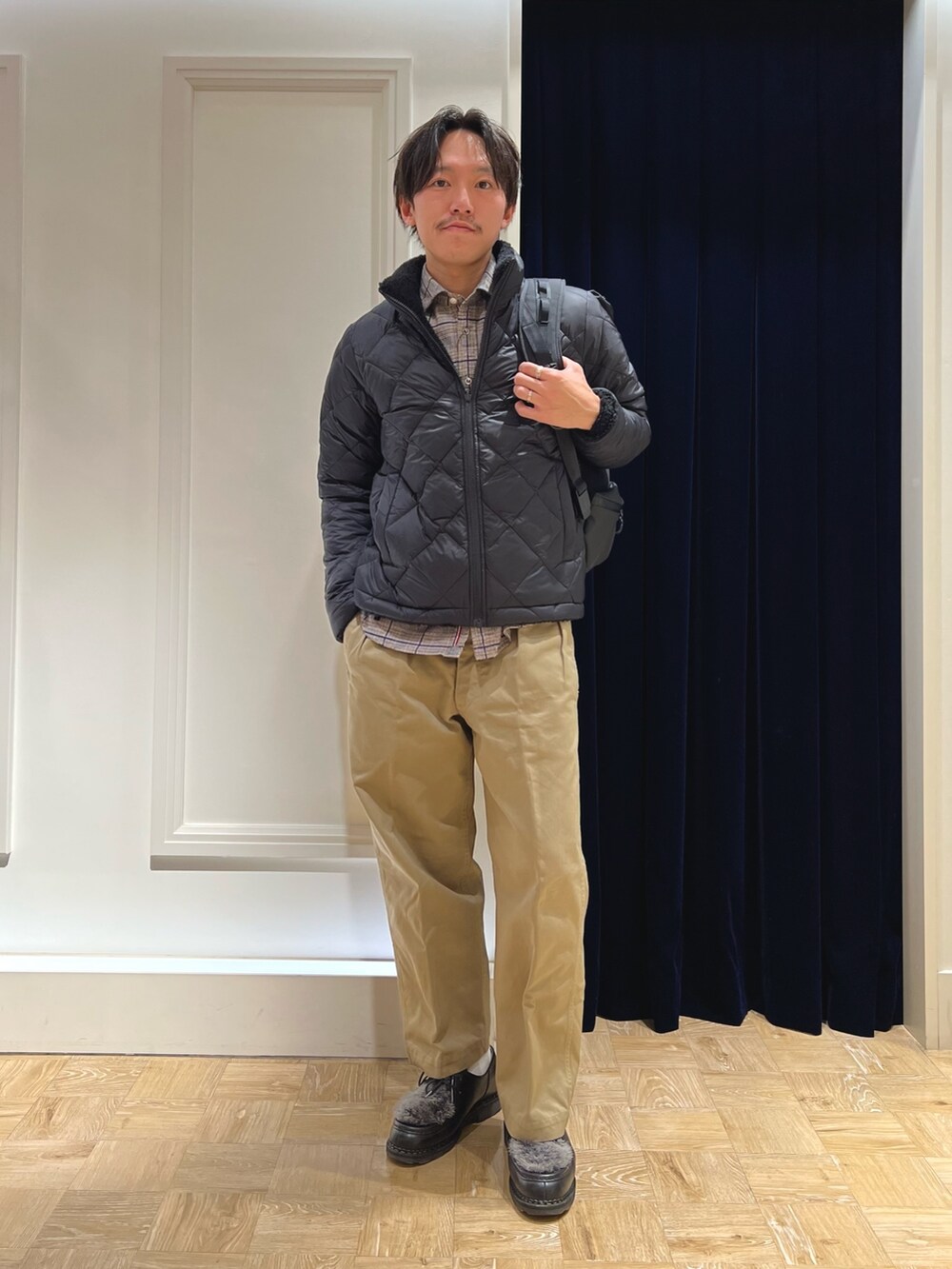 ブラック系のダウンジャケット/コート、ブラック系のシャツ/ブラウス、ブラック系のバックパック/リュックを着用したメンズの冬コーディネートの2枚目の写真