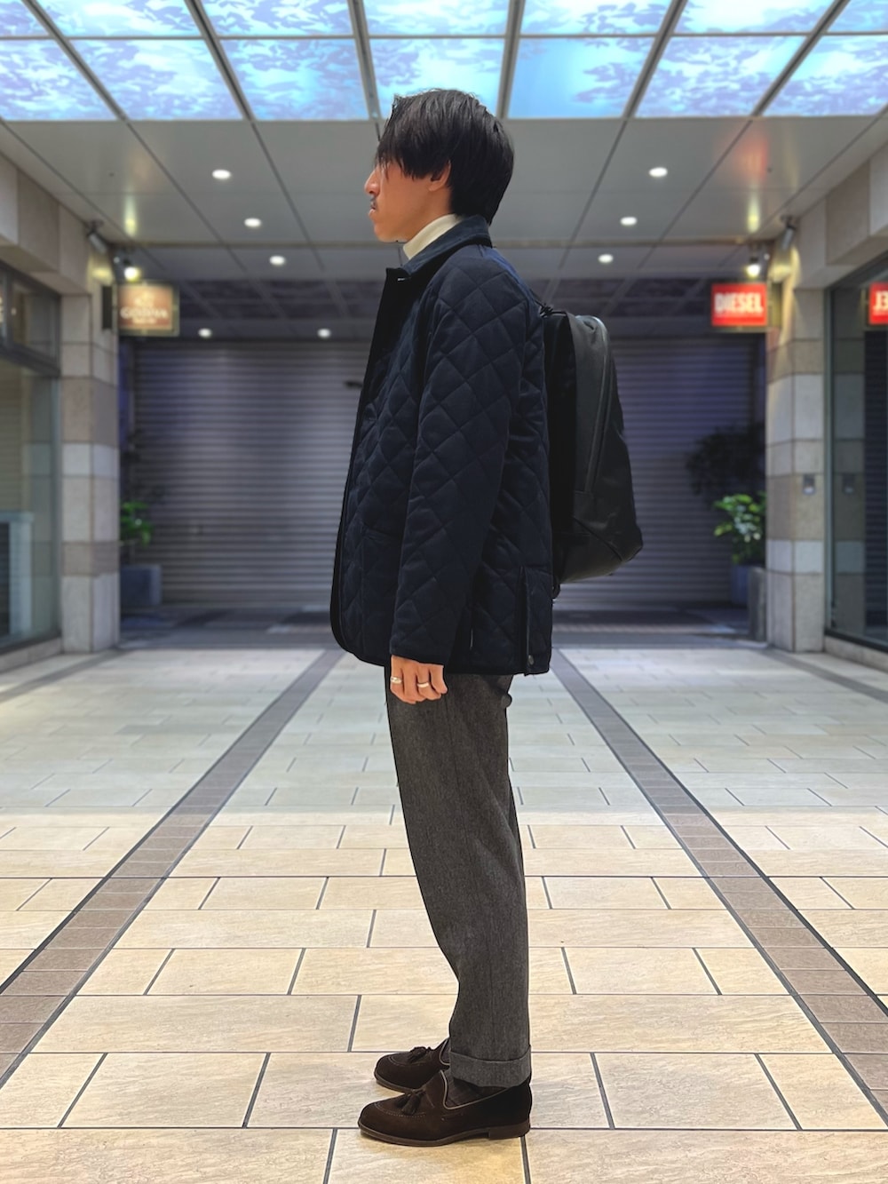 ブルー系のテーラードジャケット、ホワイト系のニット/セーター、ブラウン系のローファーを着用したメンズの冬コーディネートの4枚目の写真