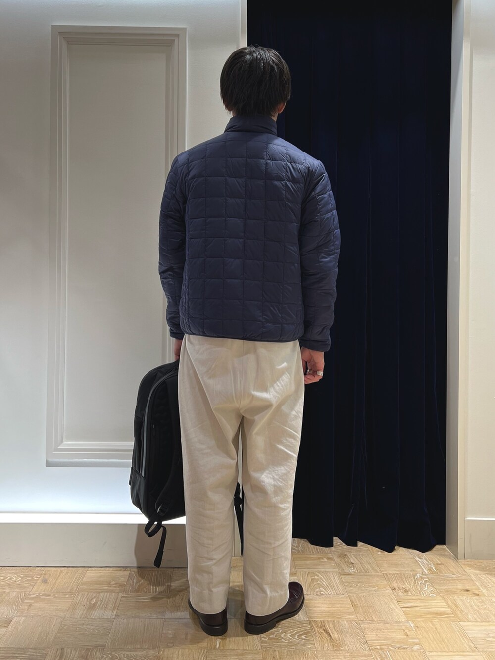 ホワイト系のダウンジャケット/コート、ブラック系のバックパック/リュックを着用したメンズの冬コーディネートの4枚目の写真