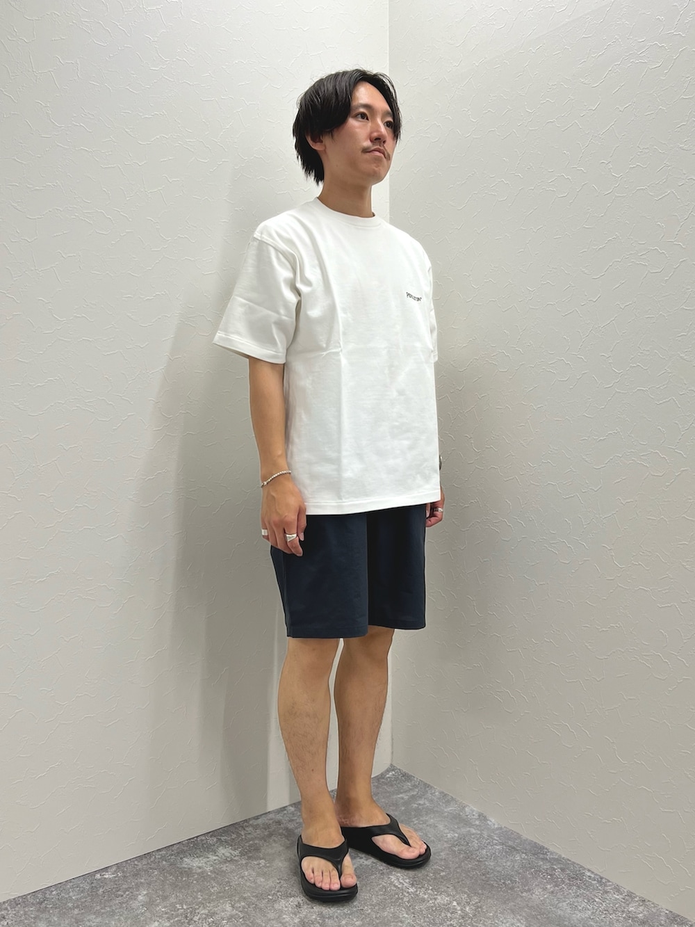 ホワイト系のTシャツ/カットソー、ブラック系のその他パンツ、ブラック系のサンダルを着用したメンズの夏コーディネートの3枚目の写真