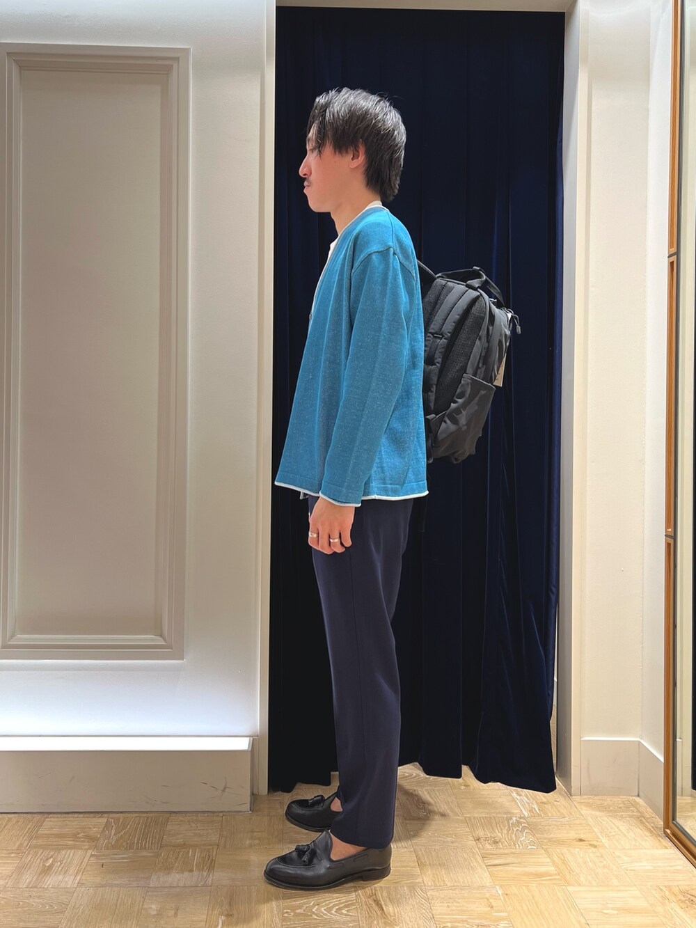 グリーン系のカーディガン/ボレロ、ブラック系のバックパック/リュックを着用したメンズの冬コーディネートの4枚目の写真